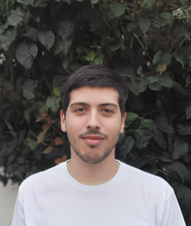 Santiago Avalos smiling in a white plaid shirt